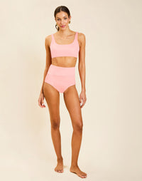 Model wearing Corinna Convertible Bikini Top in Florentine Blush, reversible solid to flourish print with straight neckline.