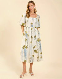 Delphine Midi Dress in Wisteria Toile with square neckline, puff sleeves, fitted bodice with back smocking, and elegant midi silhouette.