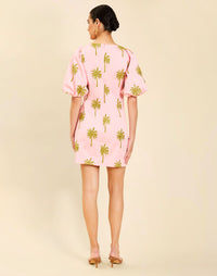 Woman wearing the Mestiza Donovan Mini Dress in English Rose, featuring a boat neckline, embroidered cotton poplin fabrication, fitted waist, balloon sleeves, subtle A-line skirt, and side seam pockets.