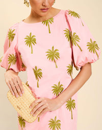 Woman wearing the Mestiza Donovan Mini Dress in English Rose, featuring a boat neckline, embroidered cotton poplin fabrication, fitted waist, balloon sleeves, subtle A-line skirt, and side seam pockets.