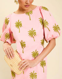 Woman wearing the Mestiza Donovan Mini Dress in English Rose, featuring a boat neckline, embroidered cotton poplin fabrication, fitted waist, balloon sleeves, subtle A-line skirt, and side seam pockets.