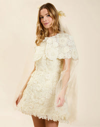 Carolina Lace Capelet in Ivory guipure lace with bow neckline detail, fitted shoulders, and elegant layering capelet silhouette.