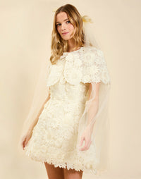 Dottie Lace Mini Dress in Ivory guipure lace with strapless neckline, structured bodice with boning, and bell-skirt mini silhouette.