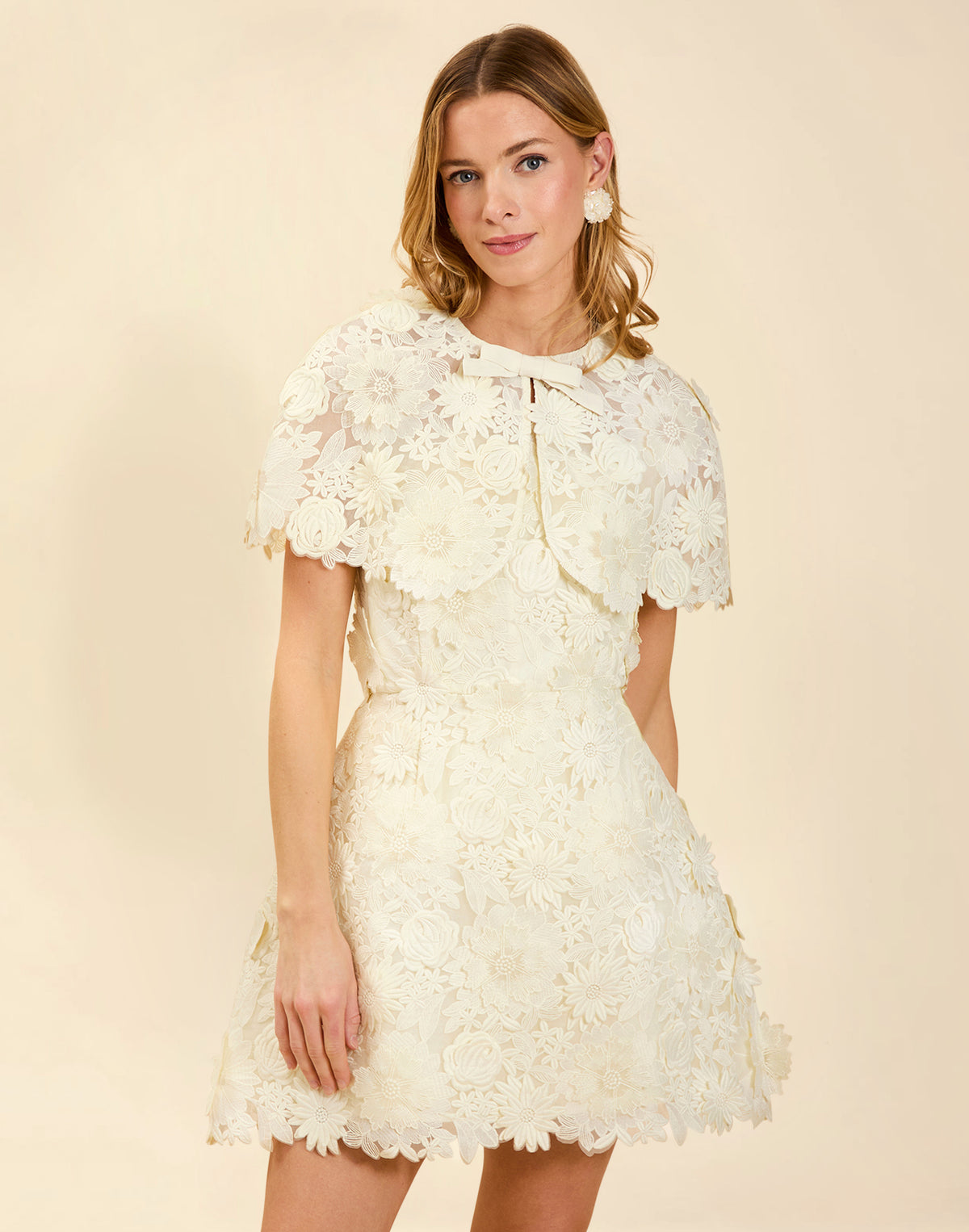 Dottie Lace Mini Dress in Ivory guipure lace with strapless neckline, structured bodice with boning, and bell-skirt mini silhouette.