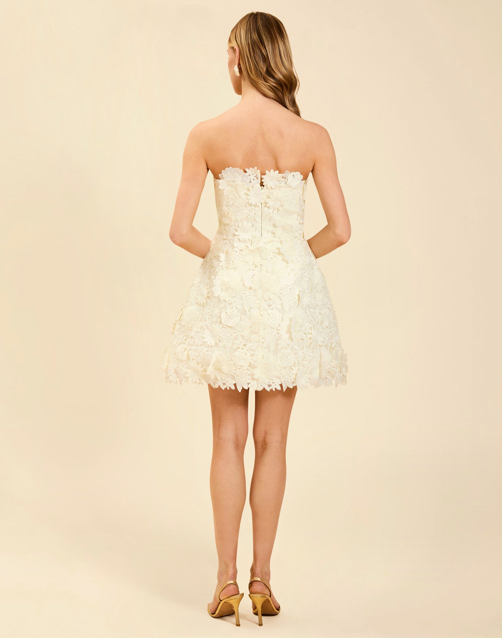 Dottie Lace Mini Dress in Ivory guipure lace with strapless neckline, structured bodice with boning, and bell-skirt mini silhouette.