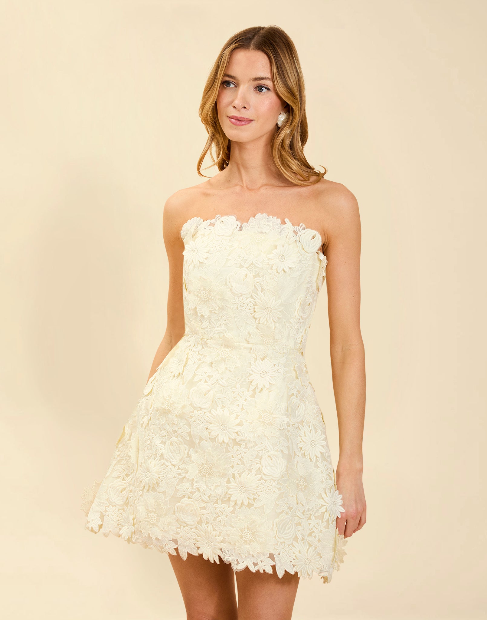 Dottie Lace Mini Dress in Ivory guipure lace with strapless neckline, structured bodice with boning, and bell-skirt mini silhouette.