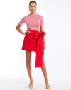 Granada Wrapped Mini Skirt in Rose Red full body – cocktail mini wrap skirt with bow-tie waist, concealed zipper, and full lining by Mestiza New York.
