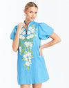 Front - Elliana Mini Dress in Cobalt Blue is an embroidered linen mini with V-neck, puff sleeves, and floral detailing.