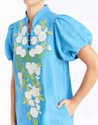Detail - Elliana Mini Dress in Cobalt Blue is an embroidered linen mini with V-neck, puff sleeves, and floral detailing.