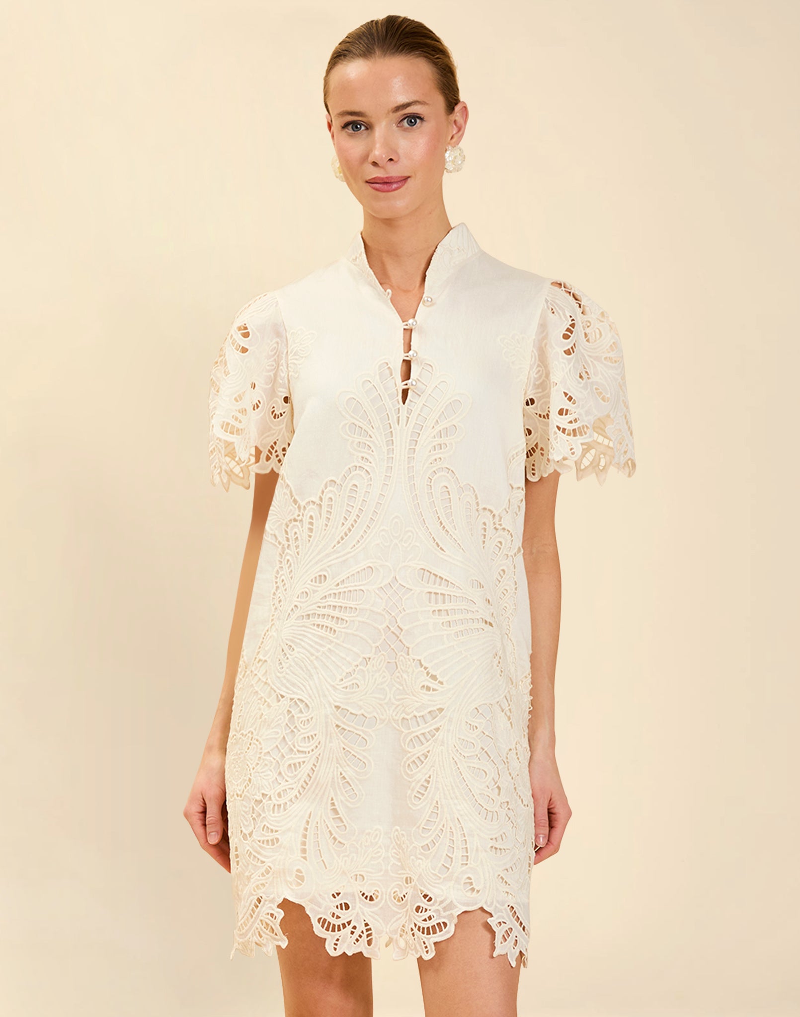 Elliana Lace Mini Dress in Ivory broderie anglaise lace with mandarin collar, pleated puff sleeves, scalloped hem, and shift mini silhouette.
