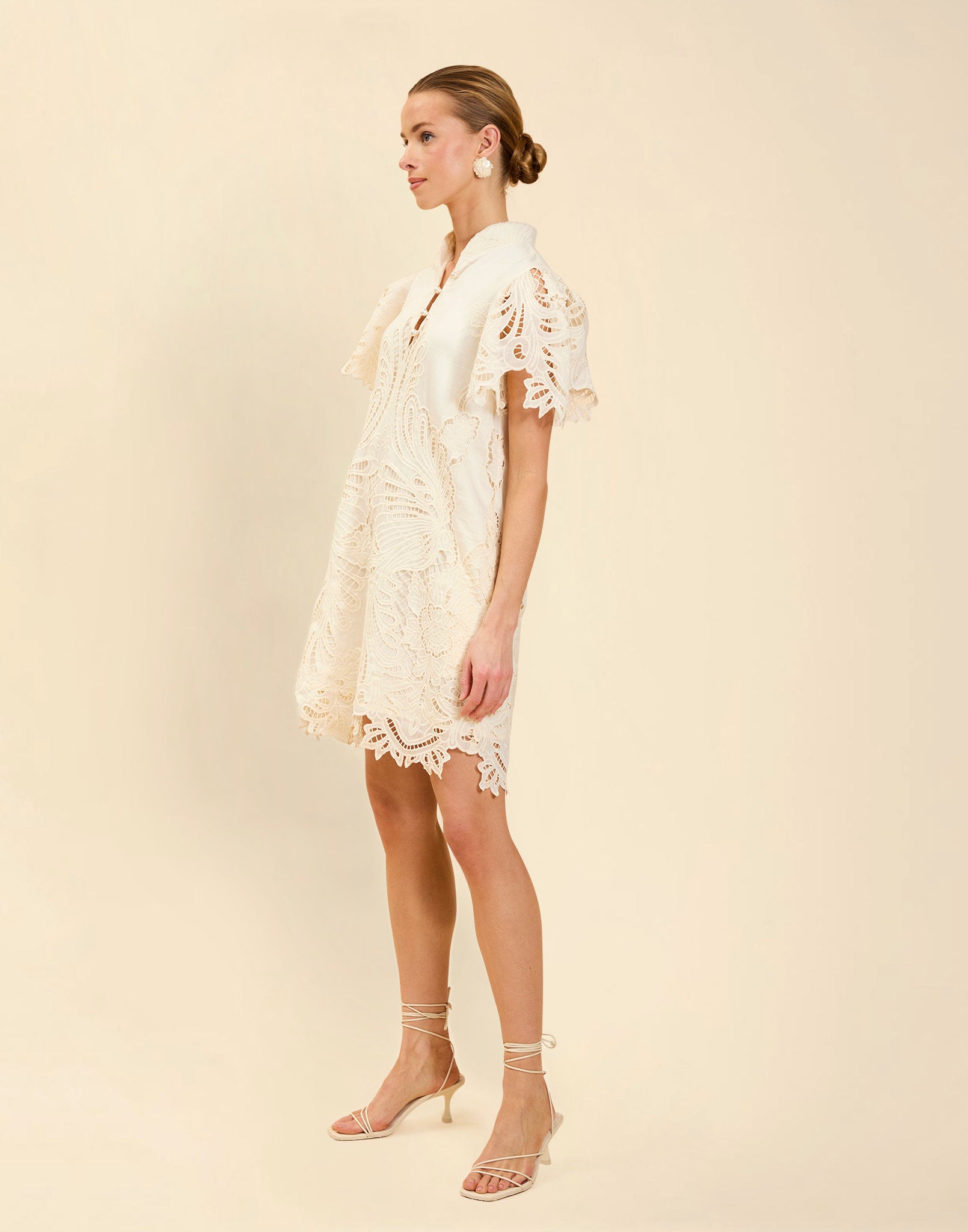 Elliana Lace Mini Dress in Ivory broderie anglaise lace with mandarin collar, pleated puff sleeves, scalloped hem, and shift mini silhouette.