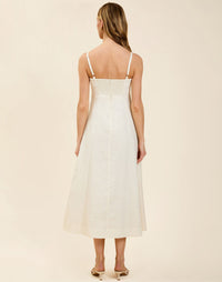 Esperanza Midi Dress in Ivory linen with 3D floral appliqué, empire bodice, adjustable straps, and elegant A-line midi skirt.
