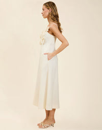 Esperanza Midi Dress in Ivory linen with 3D floral appliqué, empire bodice, adjustable straps, and elegant A-line midi skirt.
