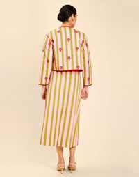 Woman wearing the Mestiza Este Convertible Jacket in Rose Provence print, featuring reversible construction, embroidered detailing, tilted diamond quilting, contrast piping, and full-length sleeves in cotton.