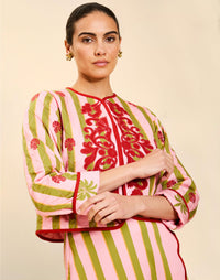Woman wearing the Mestiza Este Convertible Jacket in Rose Provence print, featuring reversible construction, embroidered detailing, tilted diamond quilting, contrast piping, and full-length sleeves in cotton.