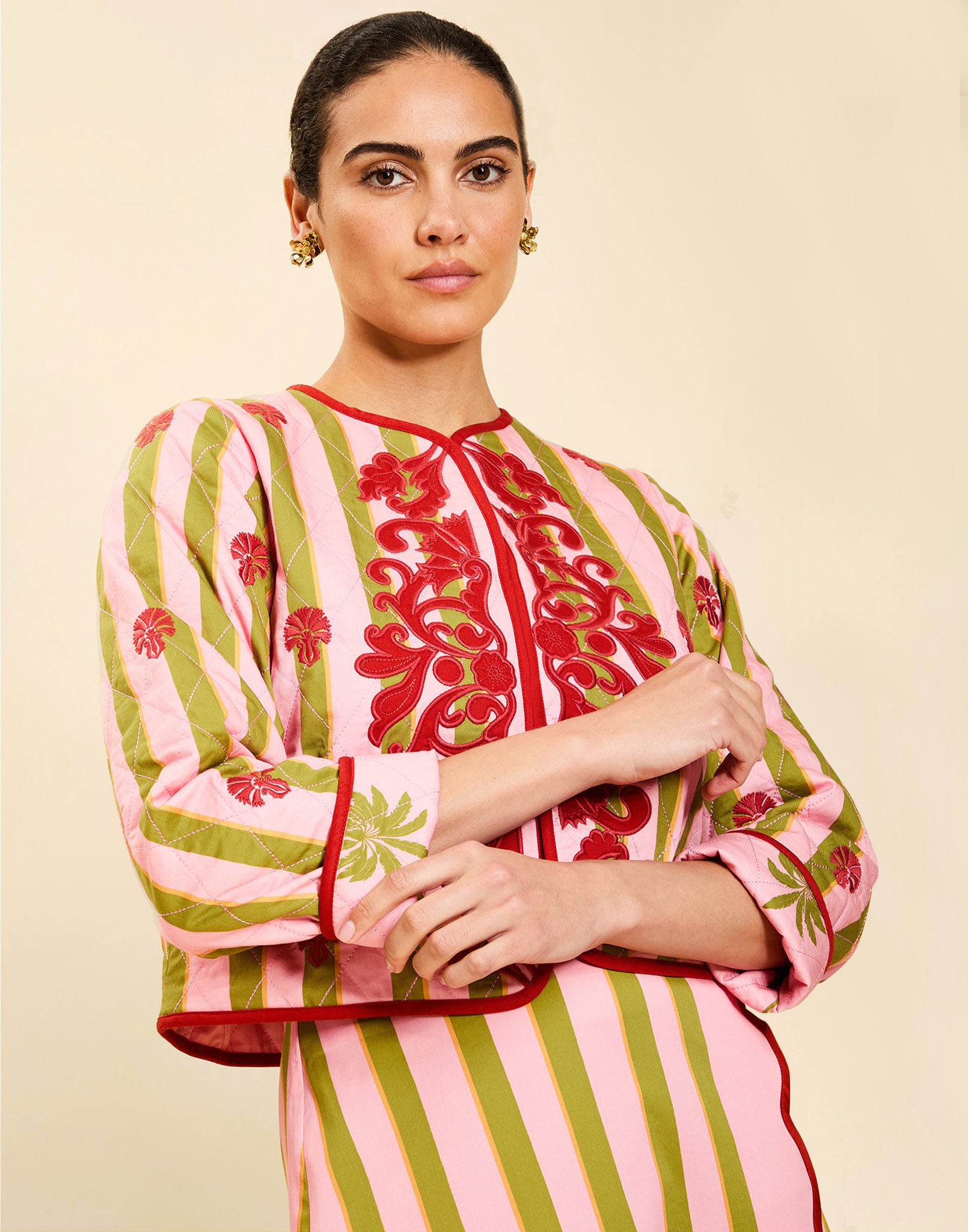 Woman wearing the Mestiza Este Convertible Jacket in Rose Provence print, featuring reversible construction, embroidered detailing, tilted diamond quilting, contrast piping, and full-length sleeves in cotton.