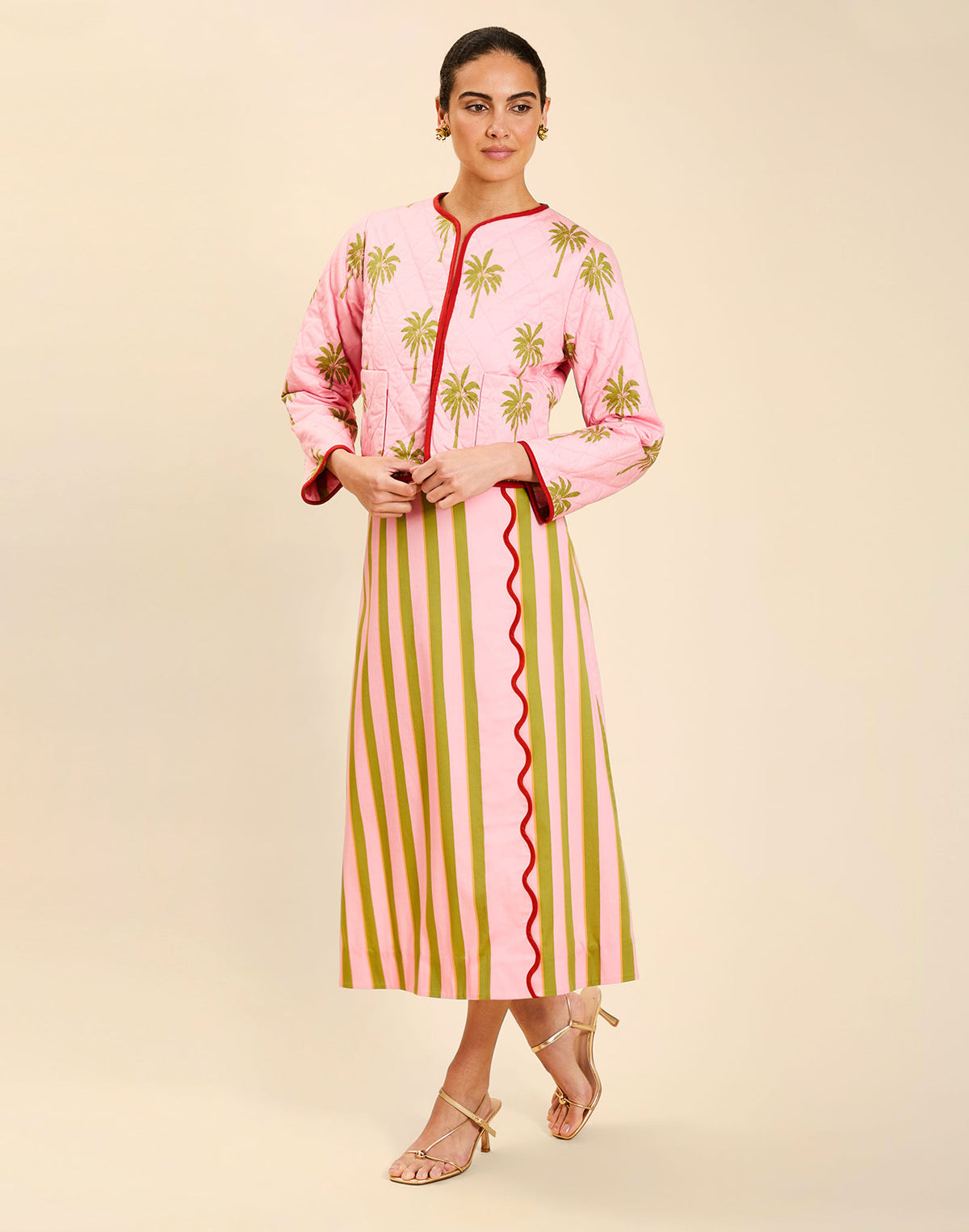 Woman wearing the Mestiza Este Convertible Jacket in Rose Provence print, featuring reversible construction, embroidered detailing, tilted diamond quilting, contrast piping, and full-length sleeves in cotton.