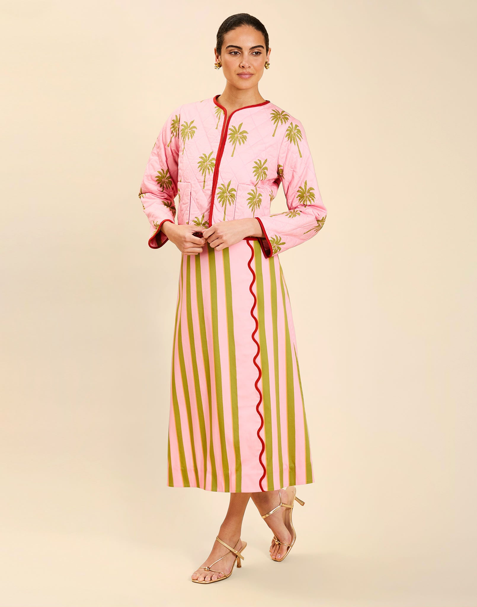 Woman wearing the Mestiza Este Convertible Jacket in Rose Provence print, featuring reversible construction, embroidered detailing, tilted diamond quilting, contrast piping, and full-length sleeves in cotton.