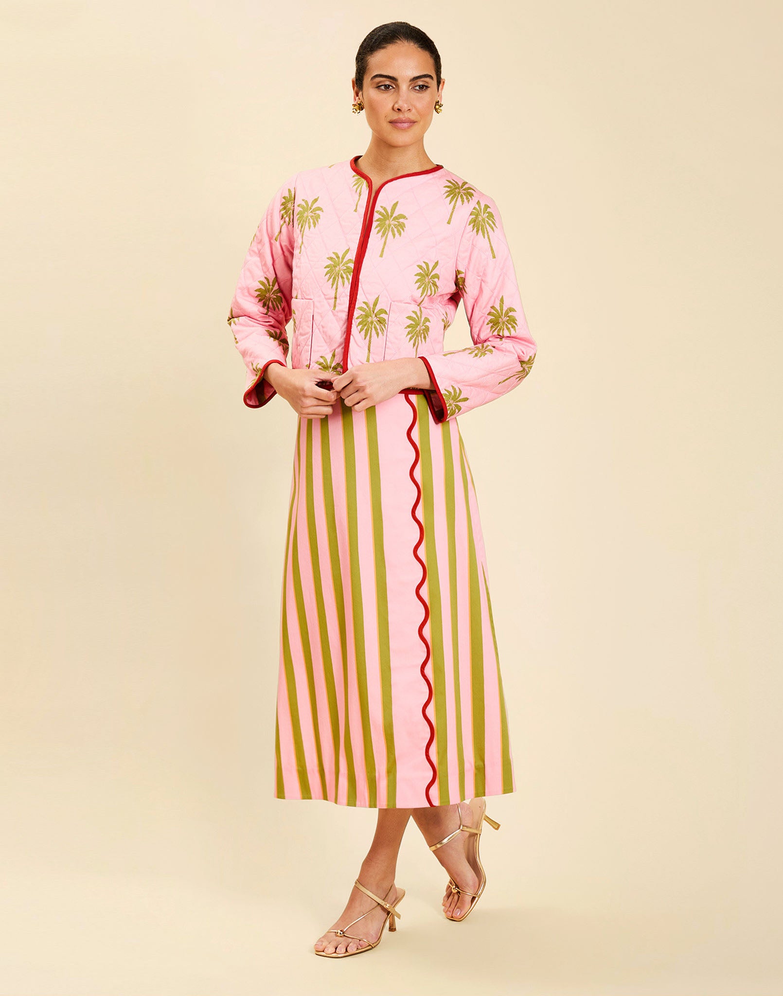 Woman wearing the Mestiza Este Convertible Jacket in Rose Provence print, featuring reversible construction, embroidered detailing, tilted diamond quilting, contrast piping, and full-length sleeves in cotton.