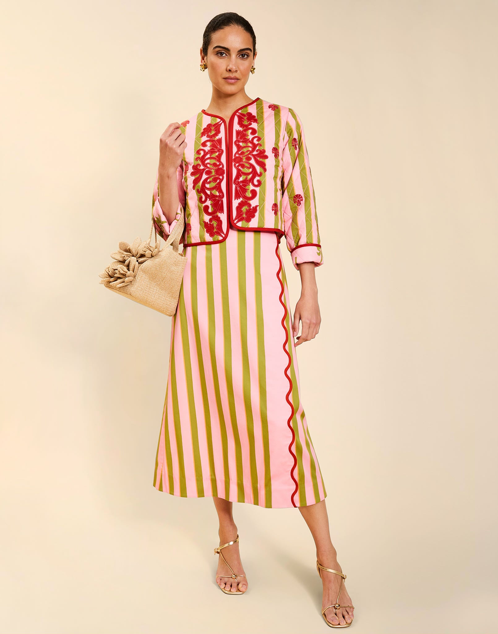 Woman wearing the Mestiza Este Convertible Jacket in Rose Provence print, featuring reversible construction, embroidered detailing, tilted diamond quilting, contrast piping, and full-length sleeves in cotton.