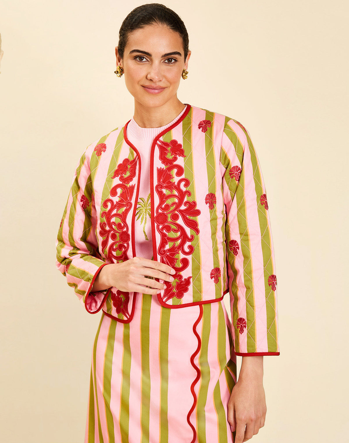 Woman wearing the Mestiza Este Convertible Jacket in Rose Provence print, featuring reversible construction, embroidered detailing, tilted diamond quilting, contrast piping, and full-length sleeves in cotton.