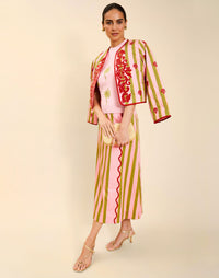 Woman wearing the Mestiza Este Convertible Jacket in Rose Provence print, featuring reversible construction, embroidered detailing, tilted diamond quilting, contrast piping, and full-length sleeves in cotton.
