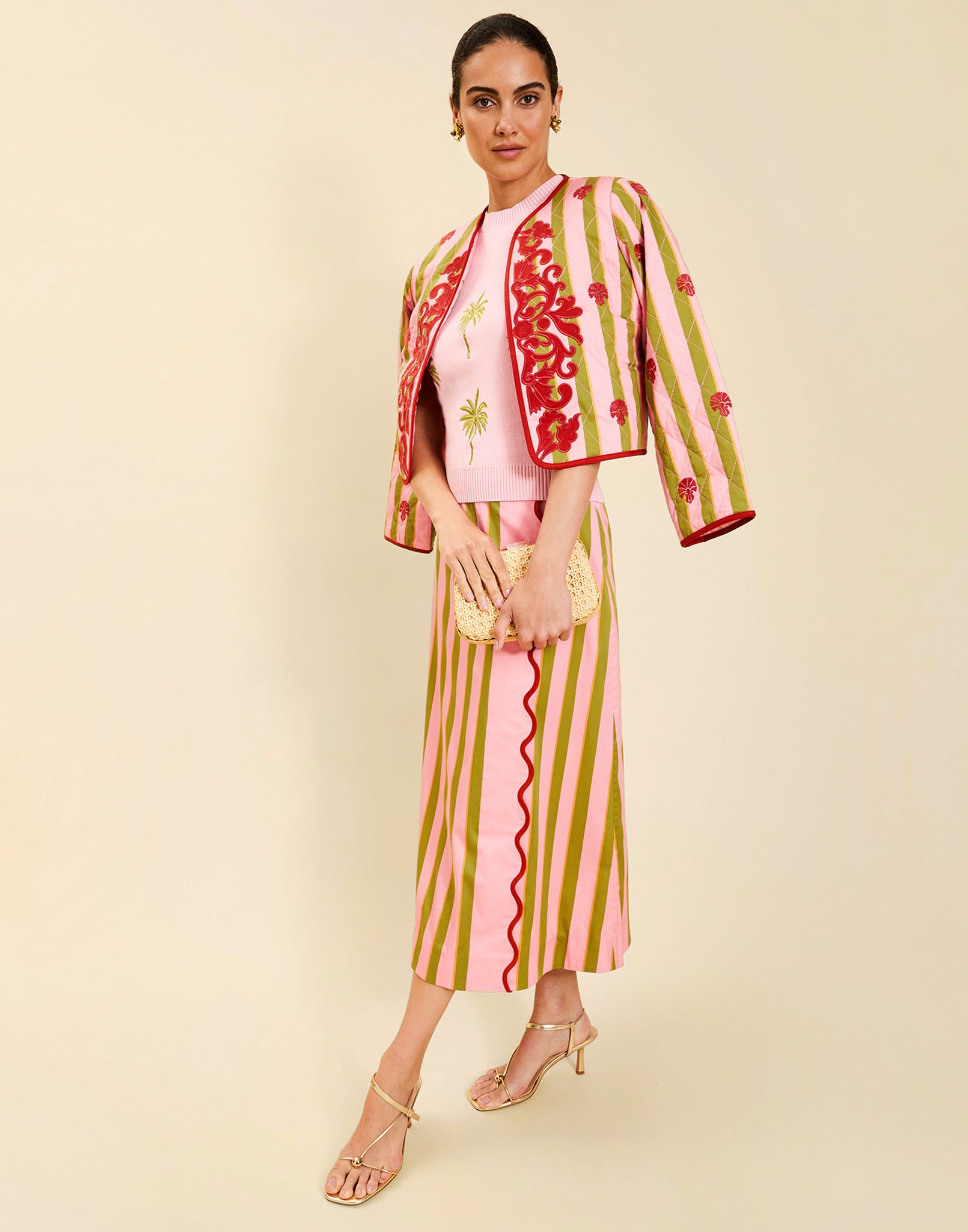 Woman wearing the Mestiza Este Convertible Jacket in Rose Provence print, featuring reversible construction, embroidered detailing, tilted diamond quilting, contrast piping, and full-length sleeves in cotton.