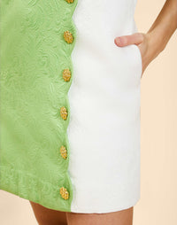 Mini A-line shift dress with scalloped faux button detailing, sleeveless tonal jacquard dress with pockets and back zipper.