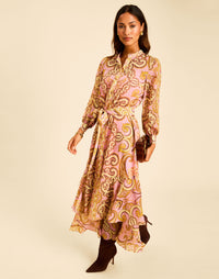 Gaia Maxi Dress in Gilded Florentina with a mandarin collar, long sleeves, tie belt, and ruffled hem.
