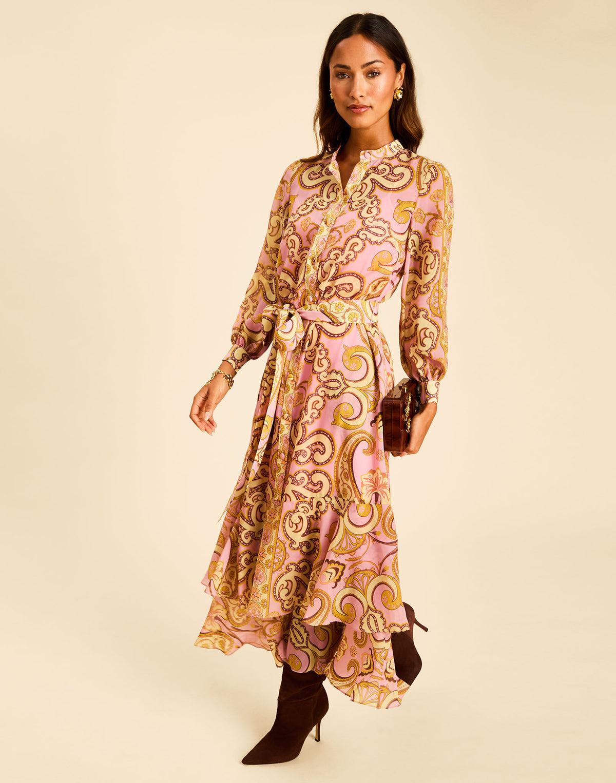 Gaia Maxi Dress in Gilded Florentina with a mandarin collar, long sleeves, tie belt, and ruffled hem.
