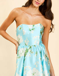 Georgiana Gown in Blue Botanica strapless poly silk twill gown with asymmetrical cascading skirt and side seam pockets.