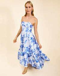 Strapless gown in Porcelain Blue Jacquard featuring a fitted bodice, cascading asymmetrical skirt, removable straps, and functional pockets.
