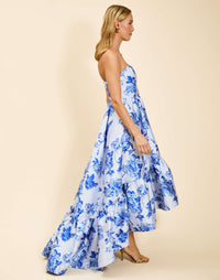 Strapless gown in Porcelain Blue Jacquard featuring a fitted bodice, cascading asymmetrical skirt, removable straps, and functional pockets.