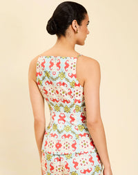 Woman wearing the Mestiza Havana Top in Quatrefoil Sierra print, featuring a bib-neck silhouette, fitted waist, princess seaming, and thin shoulder straps in crisp cotton poplin.