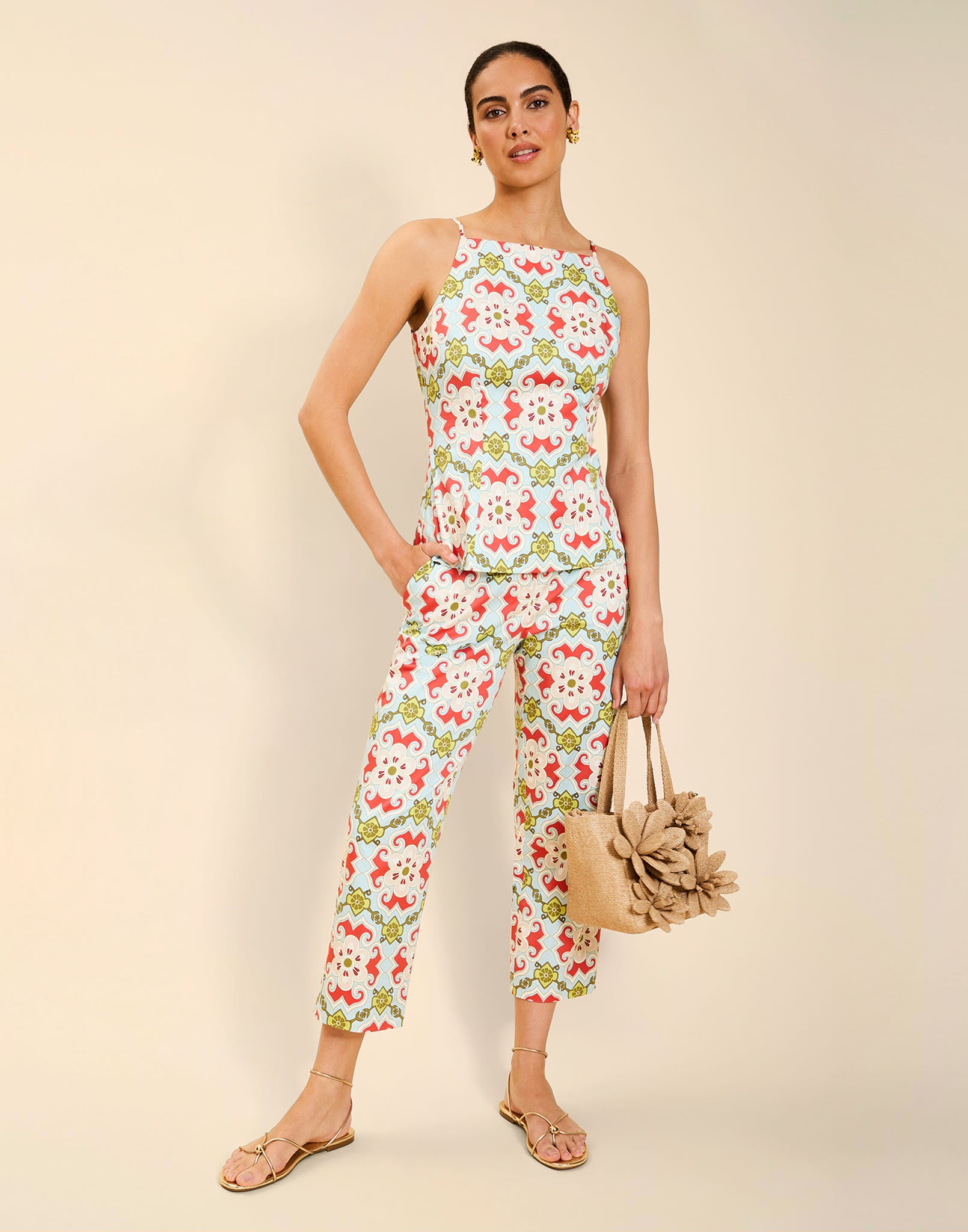 Woman wearing the Mestiza Havana Top in Quatrefoil Sierra print, featuring a bib-neck silhouette, fitted waist, princess seaming, and thin shoulder straps in crisp cotton poplin.