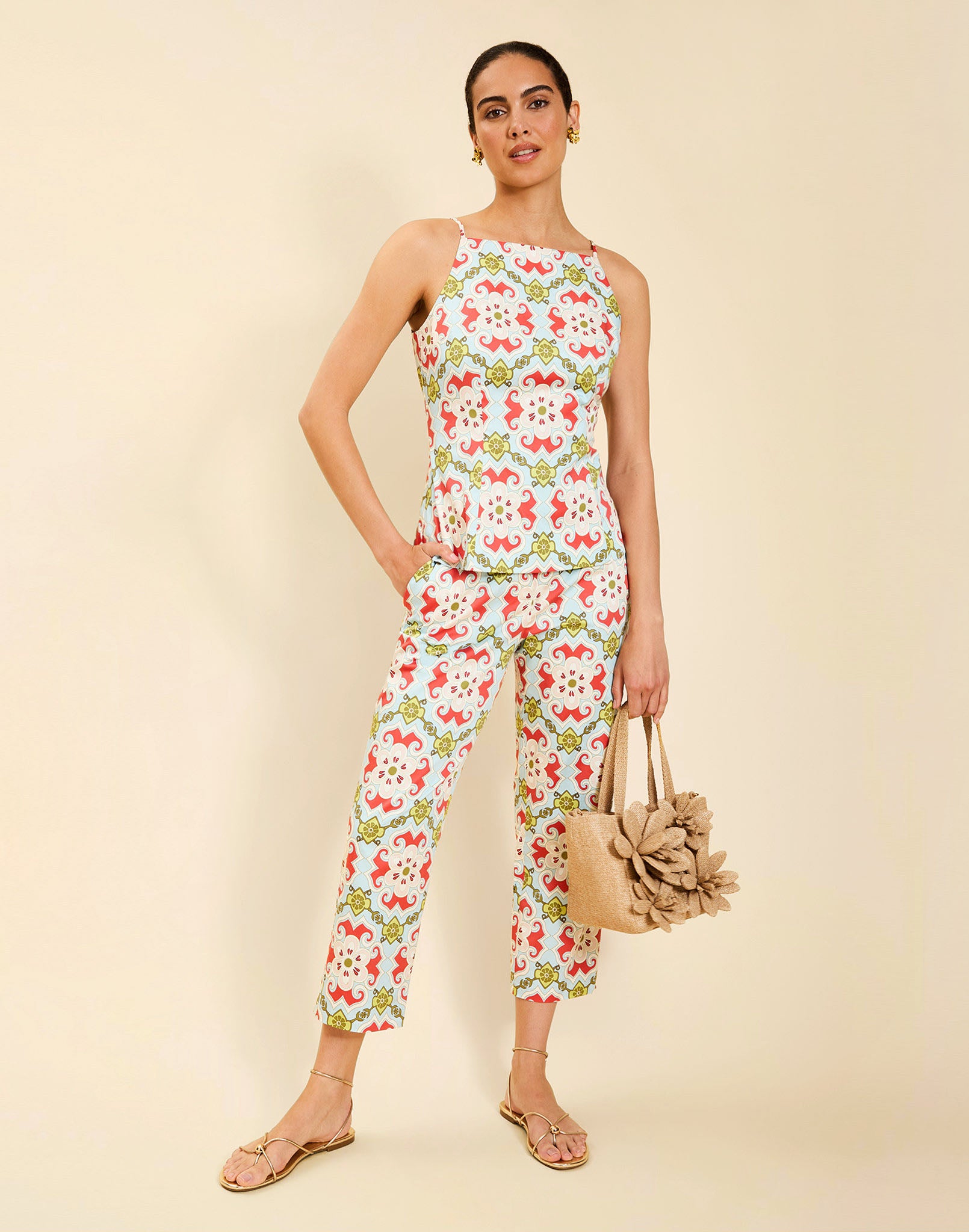 Woman wearing the Mestiza Havana Top in Quatrefoil Sierra print, featuring a bib-neck silhouette, fitted waist, princess seaming, and thin shoulder straps in crisp cotton poplin.