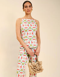 Woman wearing the Mestiza Havana Top in Quatrefoil Sierra print, featuring a bib-neck silhouette, fitted waist, princess seaming, and thin shoulder straps in crisp cotton poplin.