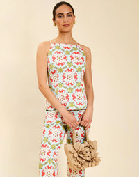 Woman wearing the Mestiza Havana Top in Quatrefoil Sierra print, featuring a bib-neck silhouette, fitted waist, princess seaming, and thin shoulder straps in crisp cotton poplin.