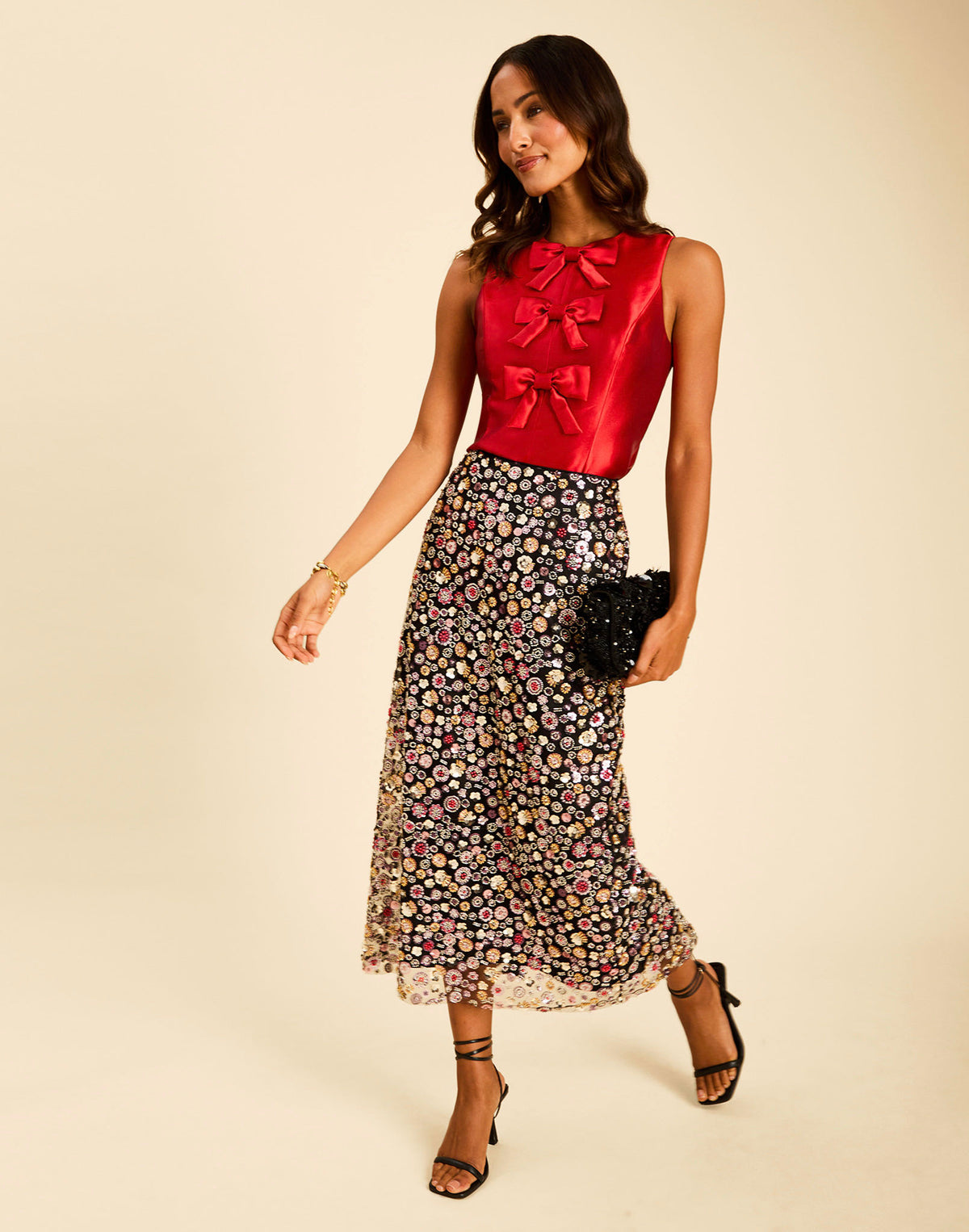 Hudson Bow Top in Merlot Red with a sleeveless crew neckline, three bows down the front, and peplum silhouette.
