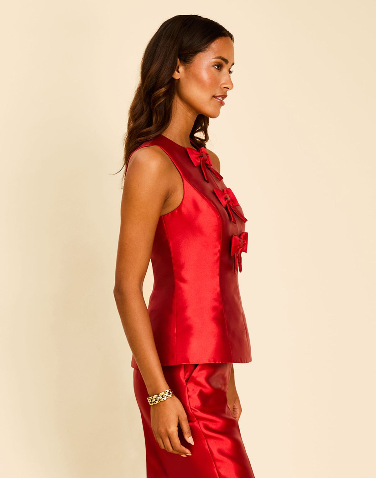 Hudson Bow Top in Merlot Red with a sleeveless crew neckline, three bows down the front, and peplum silhouette.
