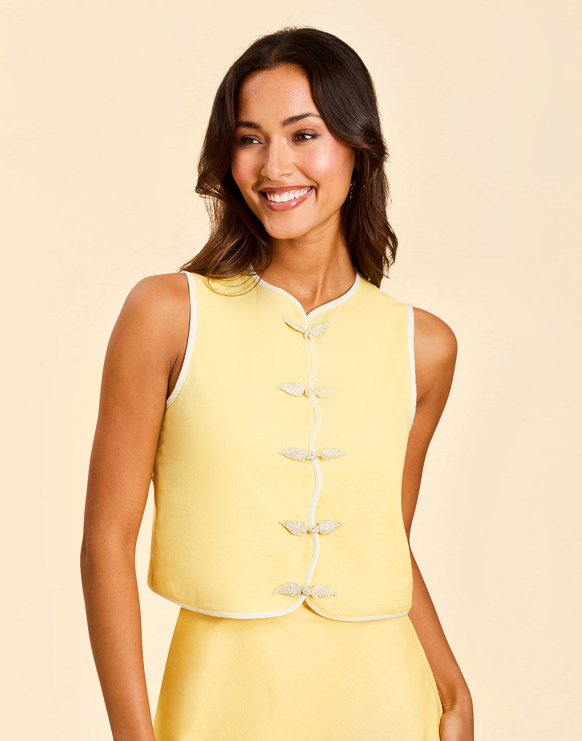 Imogen Convertible Scalloped Vest in Sunrise Meadows linen with scalloped edges, frog tie closures, and reversible yellow side.