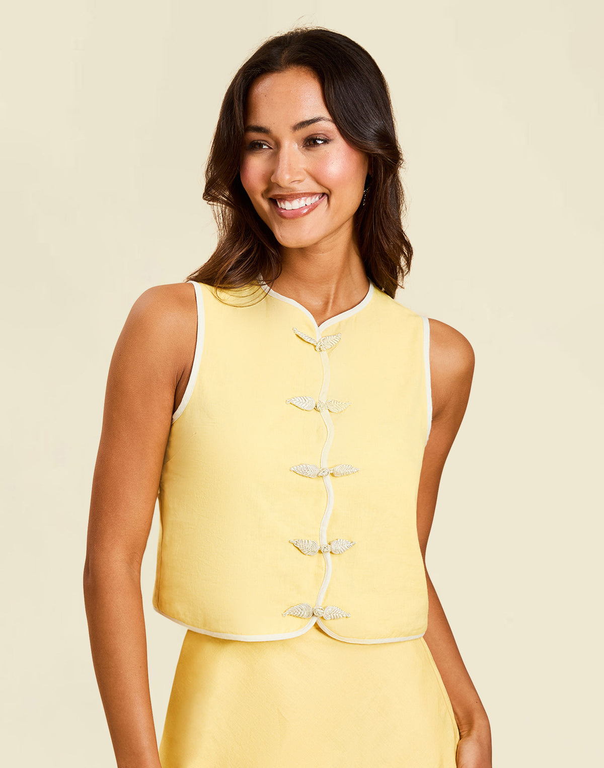 Imogen Convertible Scalloped Vest in Sunrise Meadows linen with scalloped edges, frog tie closures, and reversible yellow side.