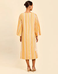 Ines Midi Caftan in Sunset Ribbons linen with embroidery detail, djellaba collar, bell sleeves, and column silhouette.