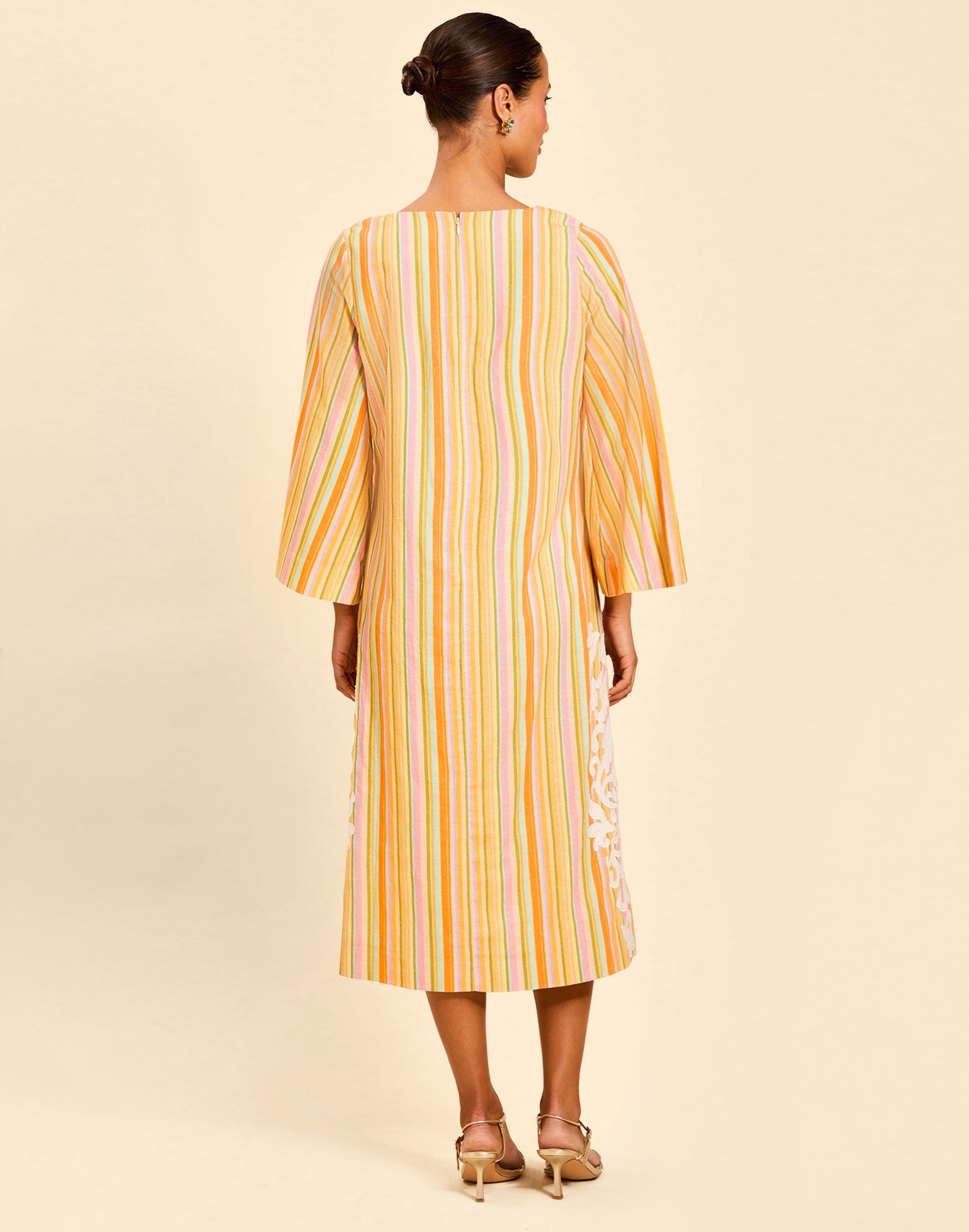 Ines Midi Caftan in Sunset Ribbons linen with embroidery detail, djellaba collar, bell sleeves, and column silhouette.
