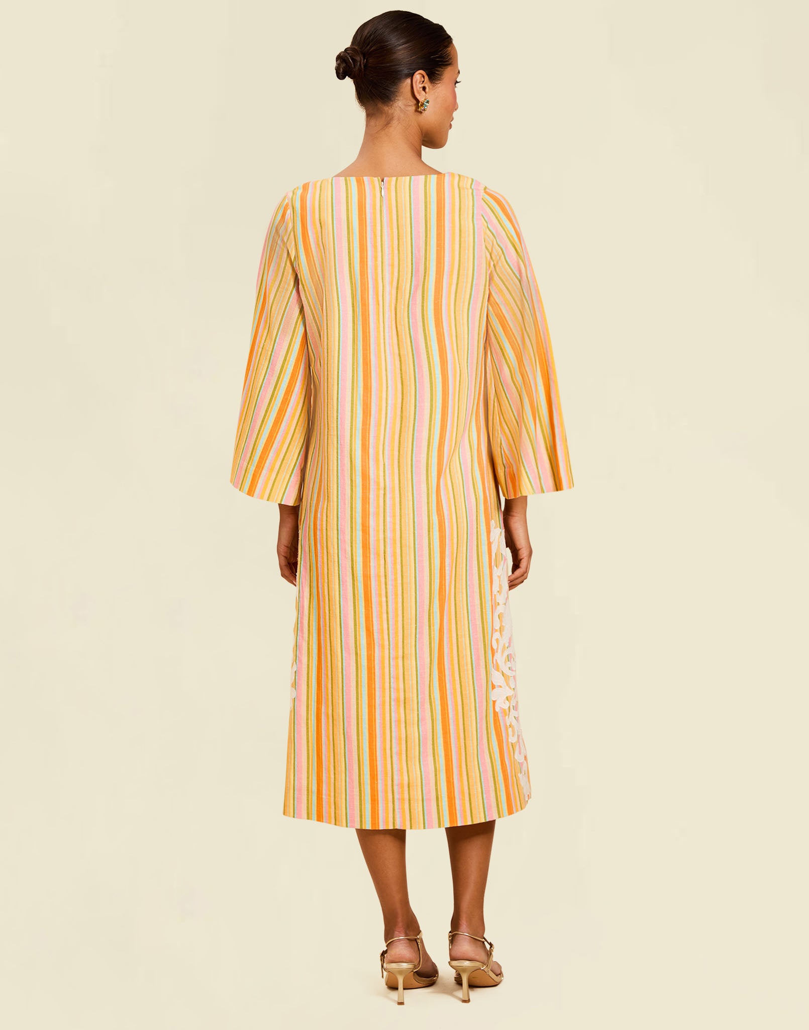 Ines Midi Caftan in Sunset Ribbons linen with embroidery detail, djellaba collar, bell sleeves, and column silhouette.