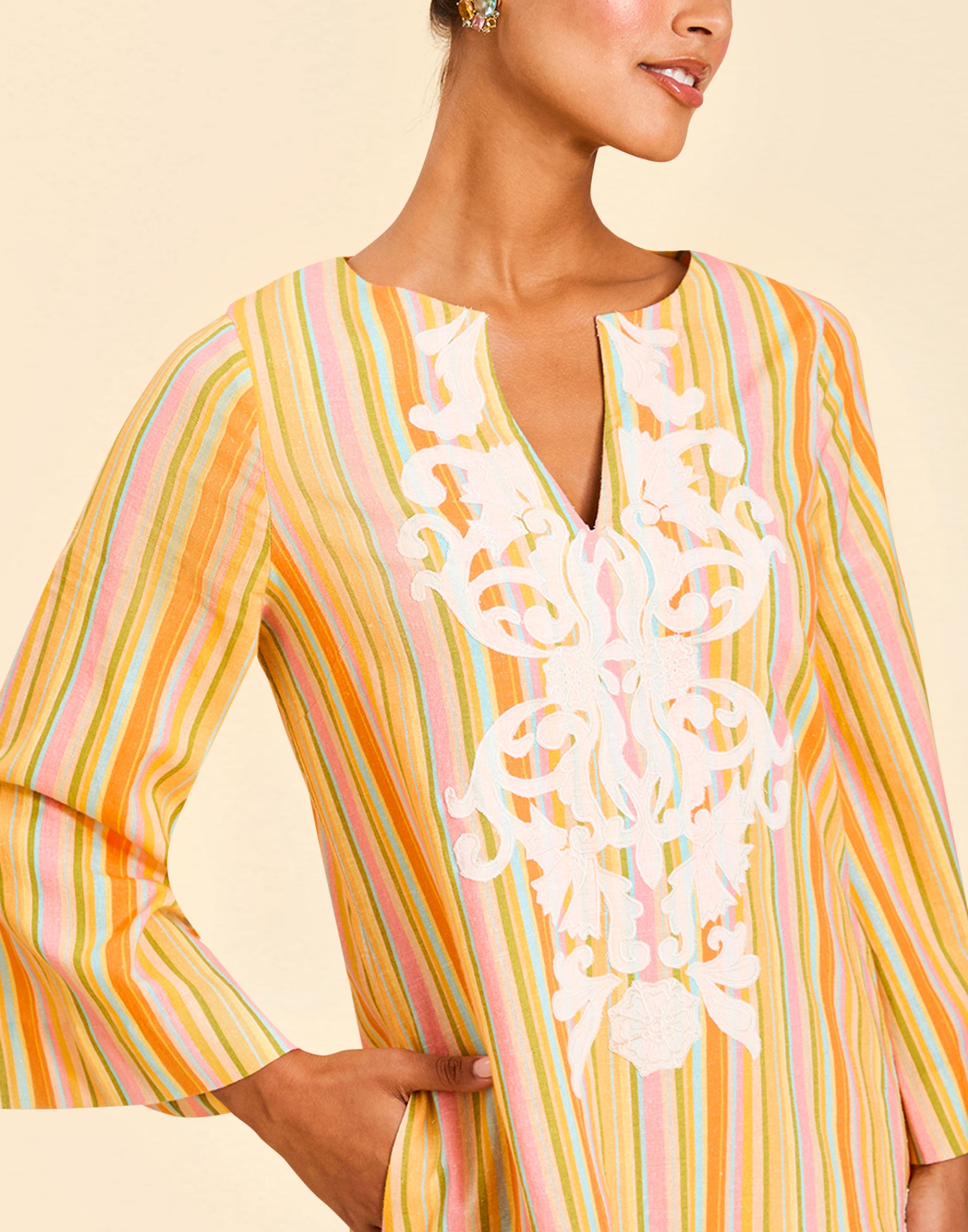 Ines Midi Caftan in Sunset Ribbons linen with embroidery detail, djellaba collar, bell sleeves, and column silhouette.