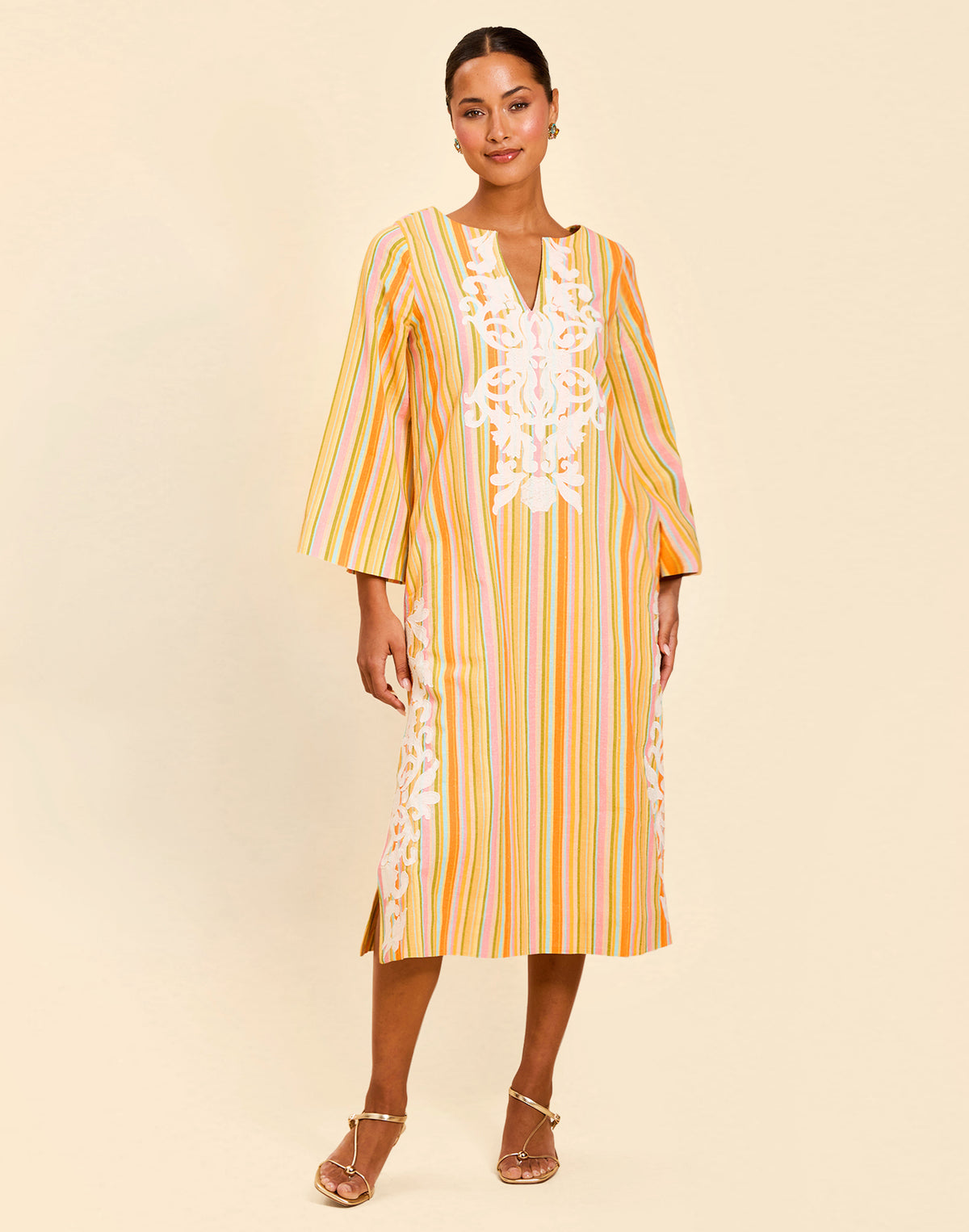 Ines Midi Caftan in Sunset Ribbons linen with embroidery detail, djellaba collar, bell sleeves, and column silhouette.
