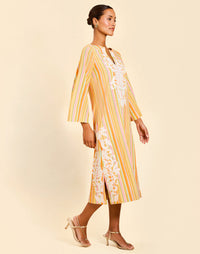 Ines Midi Caftan in Sunset Ribbons linen with embroidery detail, djellaba collar, bell sleeves, and column silhouette.