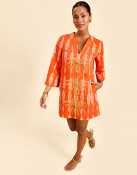 Ines Caftan Mini Dress in Hibiscus Mosaic linen with embroidered palm details, djellaba collar, and relaxed caftan silhouette.