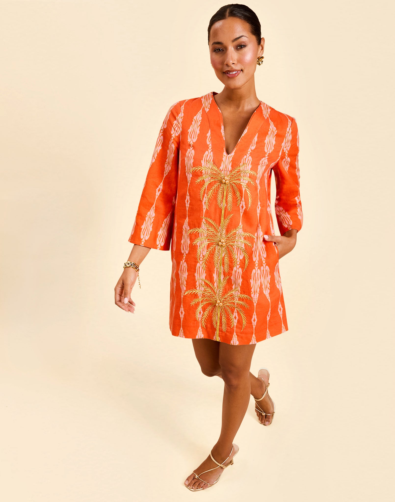 Ines Caftan Mini Dress in Hibiscus Mosaic linen with embroidered palm details, djellaba collar, and relaxed caftan silhouette.